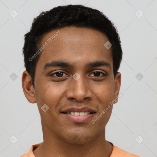 Joyful black young-adult male with short  black hair and brown eyes