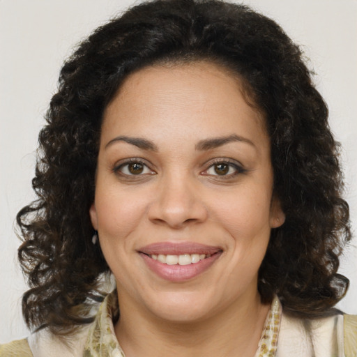 Joyful black young-adult female with medium  brown hair and brown eyes