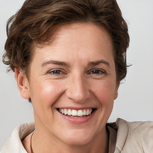 Joyful white adult female with short  brown hair and brown eyes