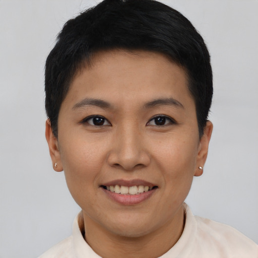 Joyful asian young-adult female with short  black hair and brown eyes