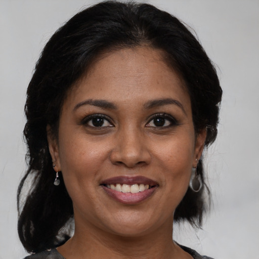 Joyful black young-adult female with medium  brown hair and brown eyes