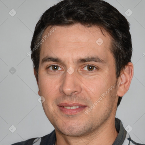 Joyful white adult male with short  black hair and brown eyes