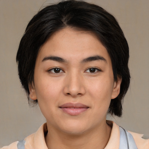 Joyful asian young-adult female with medium  brown hair and brown eyes