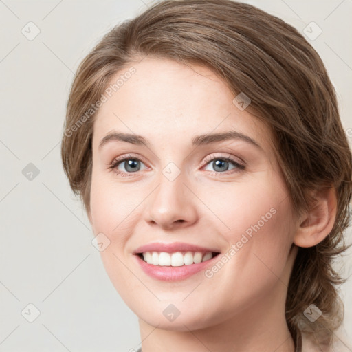 Joyful white young-adult female with medium  brown hair and green eyes