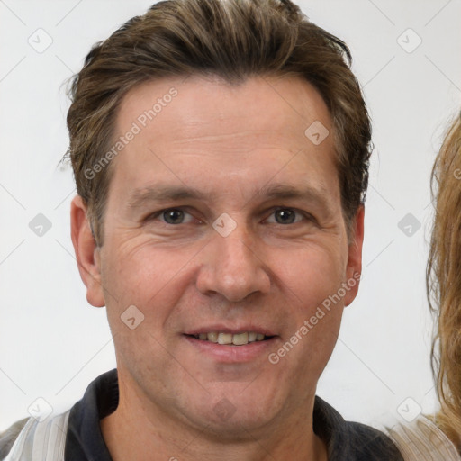 Joyful white adult male with short  brown hair and brown eyes