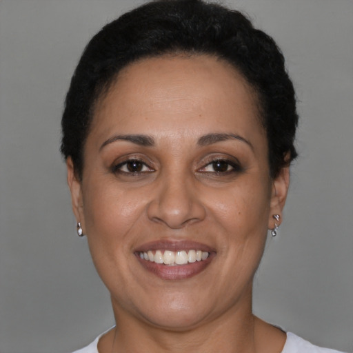 Joyful latino adult female with short  black hair and brown eyes