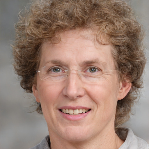 Joyful white middle-aged female with medium  brown hair and grey eyes