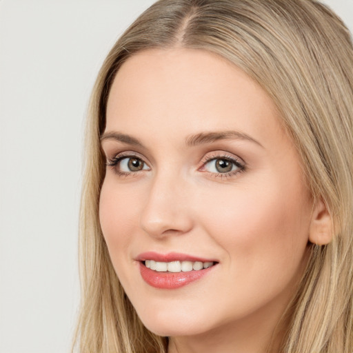 Joyful white young-adult female with long  brown hair and blue eyes