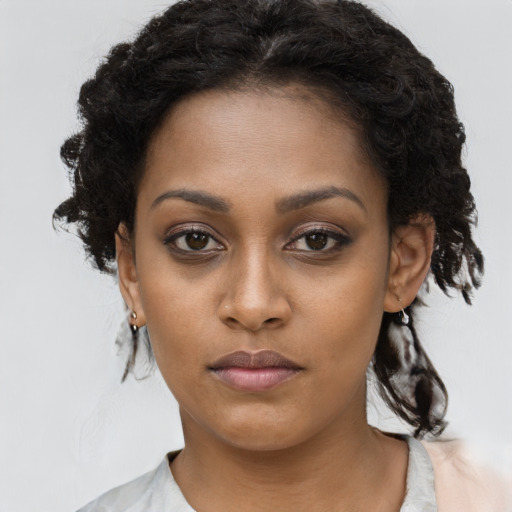 Neutral black young-adult female with medium  brown hair and brown eyes