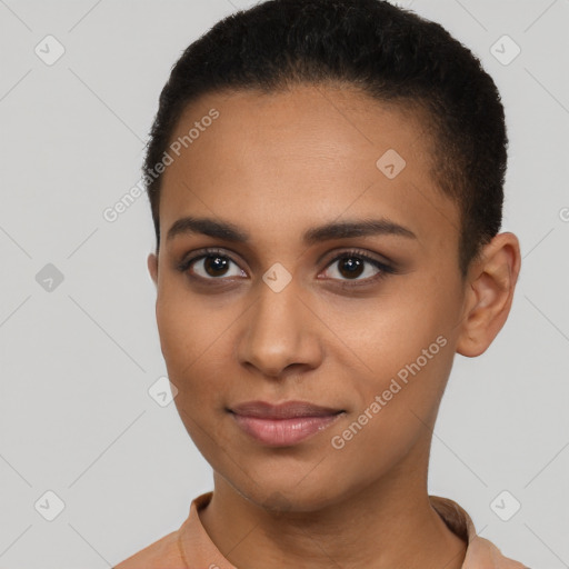 Joyful black young-adult female with short  brown hair and brown eyes