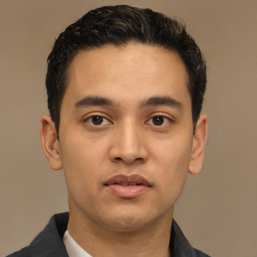Joyful latino young-adult male with short  black hair and brown eyes