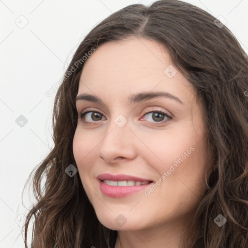 Joyful white young-adult female with long  brown hair and green eyes