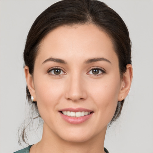 Joyful white young-adult female with medium  brown hair and brown eyes