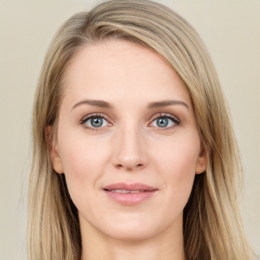 Joyful white young-adult female with long  brown hair and blue eyes