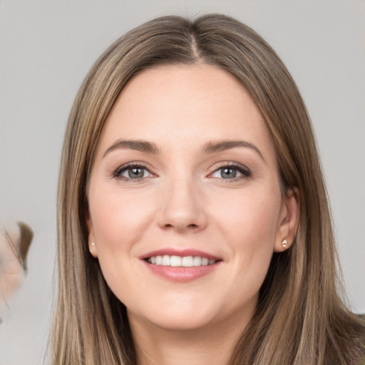 Joyful white young-adult female with long  brown hair and grey eyes