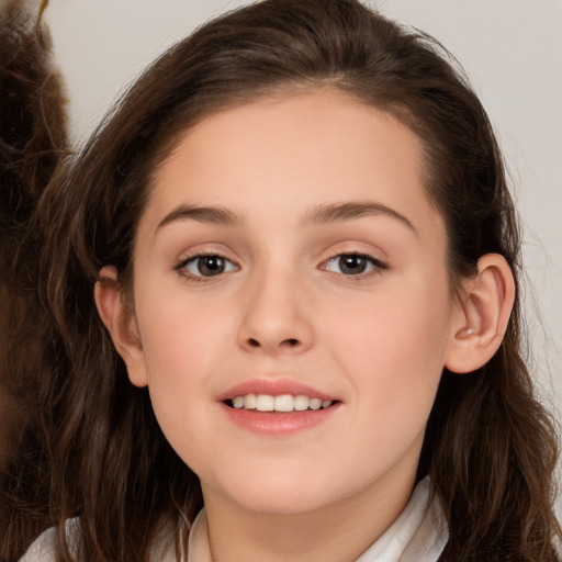 Joyful white child female with long  brown hair and brown eyes