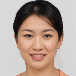 Joyful asian young-adult female with medium  brown hair and brown eyes