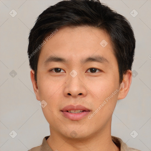 Joyful asian young-adult male with short  brown hair and brown eyes