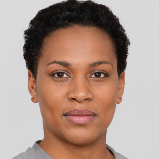 Joyful black young-adult female with short  brown hair and brown eyes