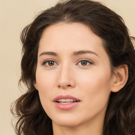 Joyful white young-adult female with long  brown hair and brown eyes