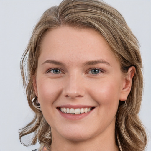 Joyful white young-adult female with medium  brown hair and blue eyes