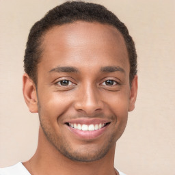 Joyful black young-adult male with short  brown hair and brown eyes