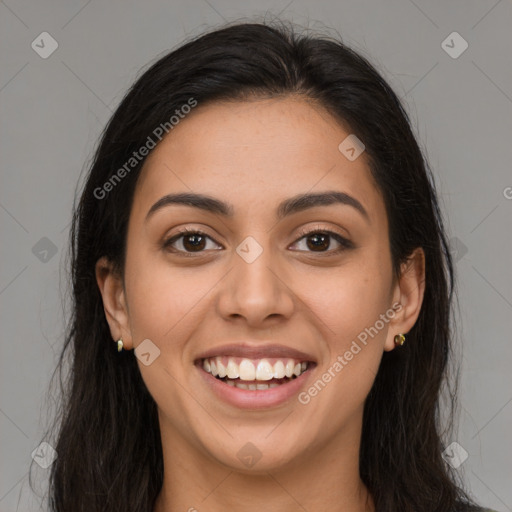 Joyful latino young-adult female with long  brown hair and brown eyes