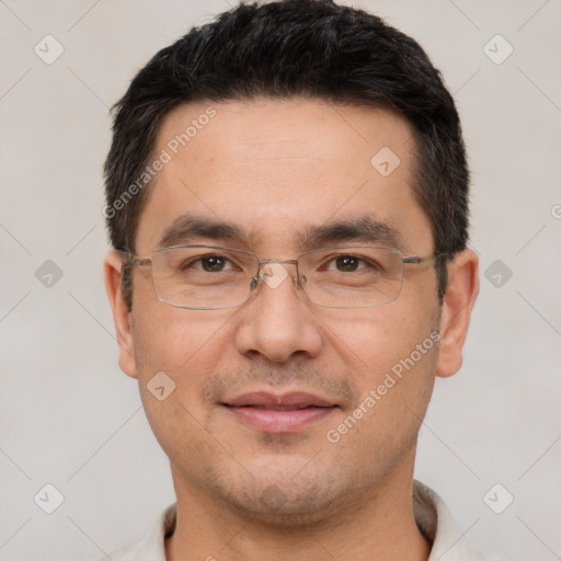 Joyful white adult male with short  black hair and brown eyes