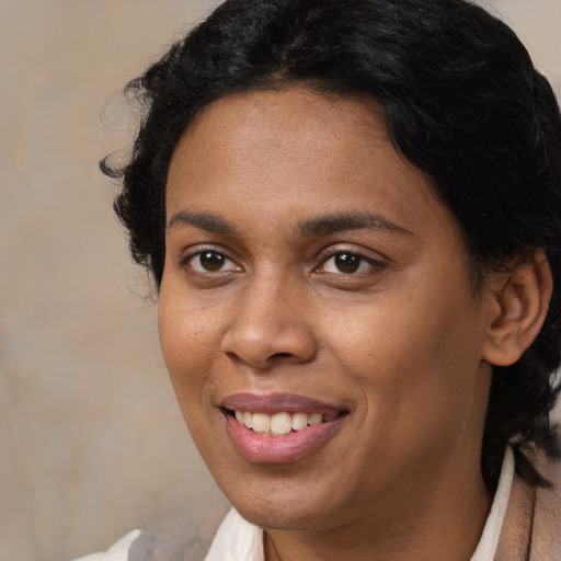 Joyful black young-adult female with short  brown hair and brown eyes