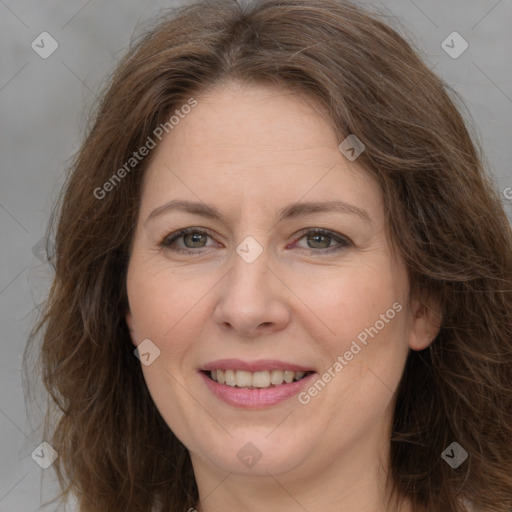 Joyful white adult female with long  brown hair and brown eyes