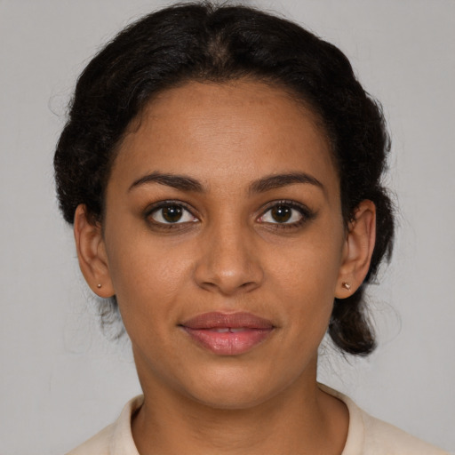 Joyful latino young-adult female with short  brown hair and brown eyes