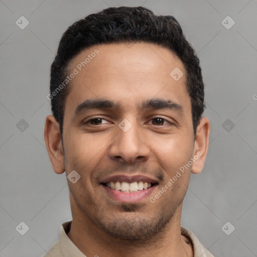 Joyful latino young-adult male with short  black hair and brown eyes