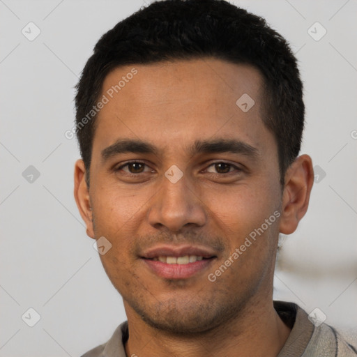 Joyful latino young-adult male with short  brown hair and brown eyes