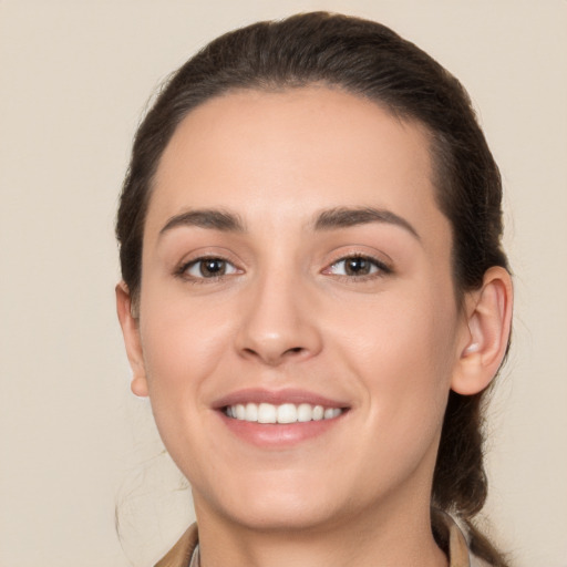 Joyful white young-adult female with long  brown hair and brown eyes