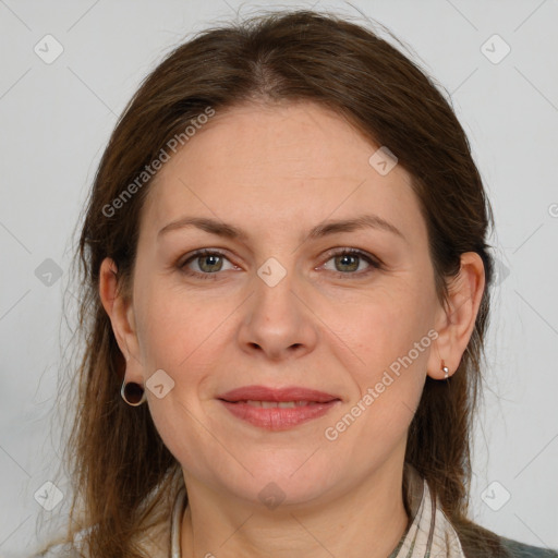 Joyful white adult female with medium  brown hair and grey eyes