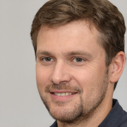 Joyful white adult male with short  brown hair and brown eyes