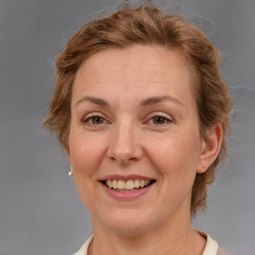 Joyful white adult female with medium  brown hair and brown eyes