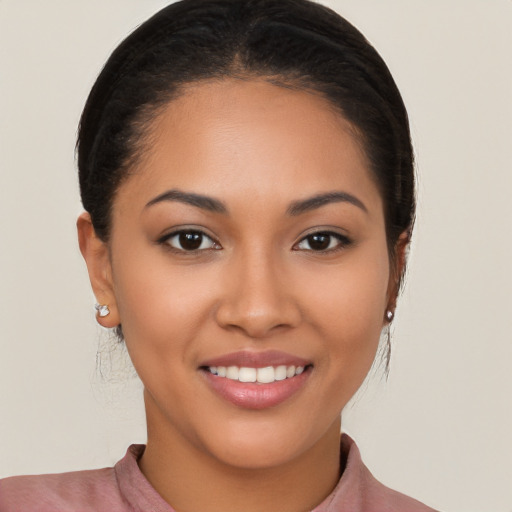 Joyful latino young-adult female with long  brown hair and brown eyes