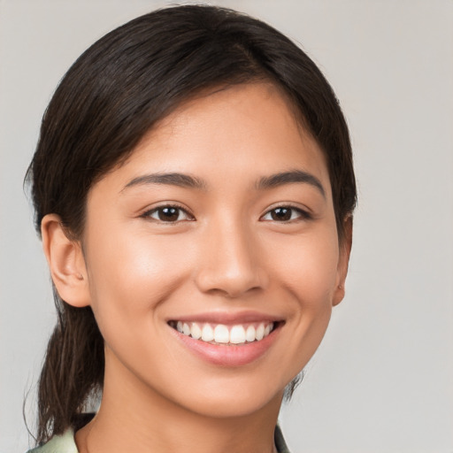 Joyful white young-adult female with medium  brown hair and brown eyes