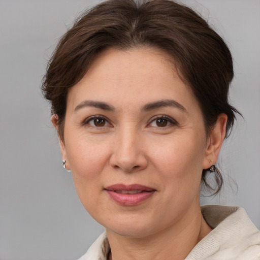 Joyful white adult female with medium  brown hair and brown eyes