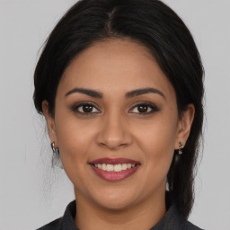 Joyful white young-adult female with medium  brown hair and brown eyes