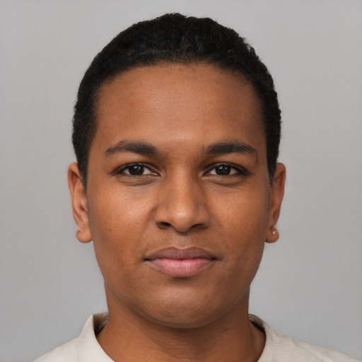 Joyful black young-adult male with short  black hair and brown eyes