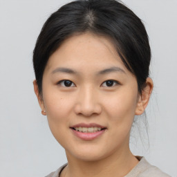 Joyful asian young-adult female with short  brown hair and brown eyes