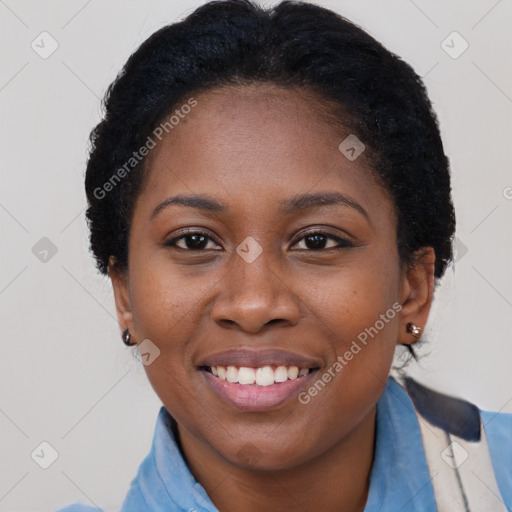 Joyful black young-adult female with short  black hair and brown eyes