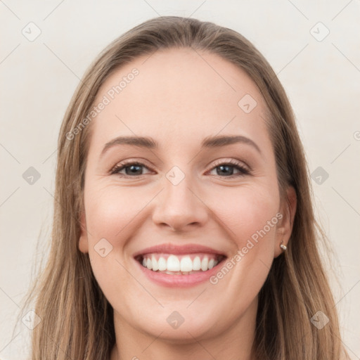 Joyful white young-adult female with long  brown hair and grey eyes