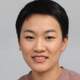 Joyful asian young-adult female with short  black hair and brown eyes