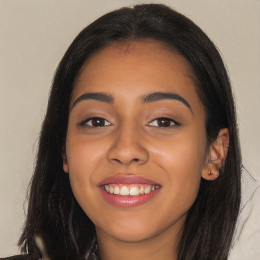 Joyful latino young-adult female with long  black hair and brown eyes