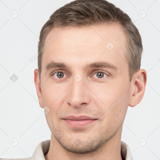 Joyful white young-adult male with short  brown hair and brown eyes