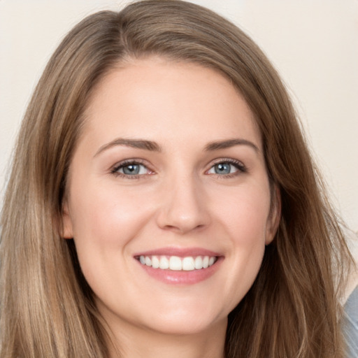 Joyful white young-adult female with long  brown hair and grey eyes