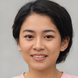 Joyful asian young-adult female with medium  brown hair and brown eyes